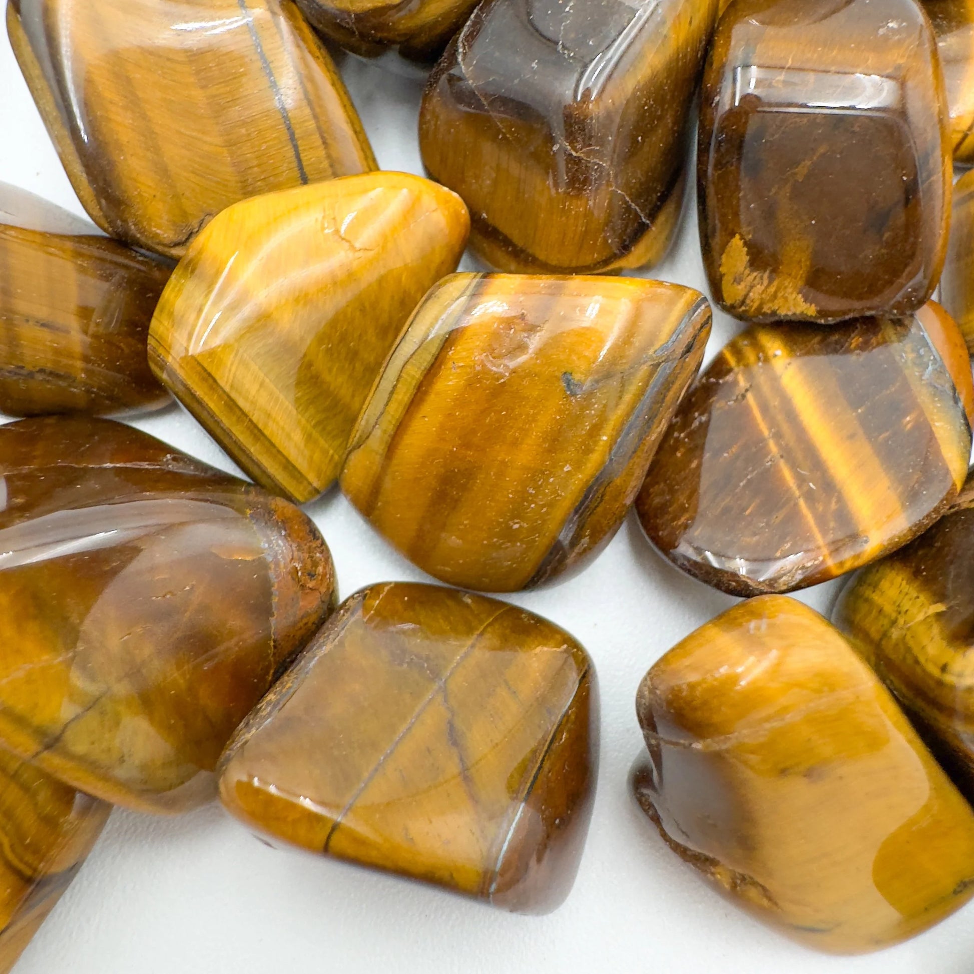 Looking down on Tiger Eye tumbled stone, associated with Confidence and Career, sourced from Northern Cape, South Africa.