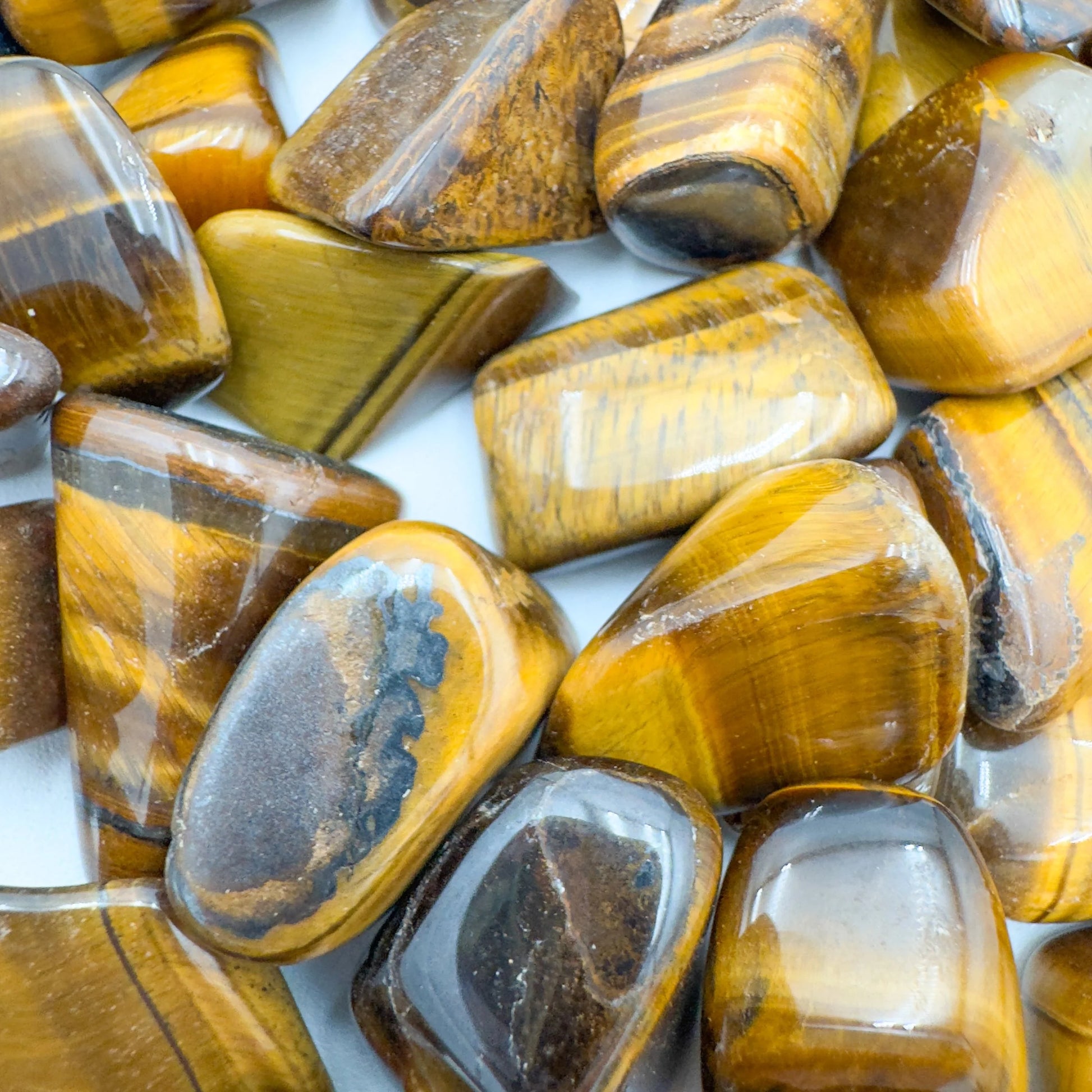 Reverse angle of Tiger Eye tumbled stone, sourced from South Africa, kept close for Confidence.