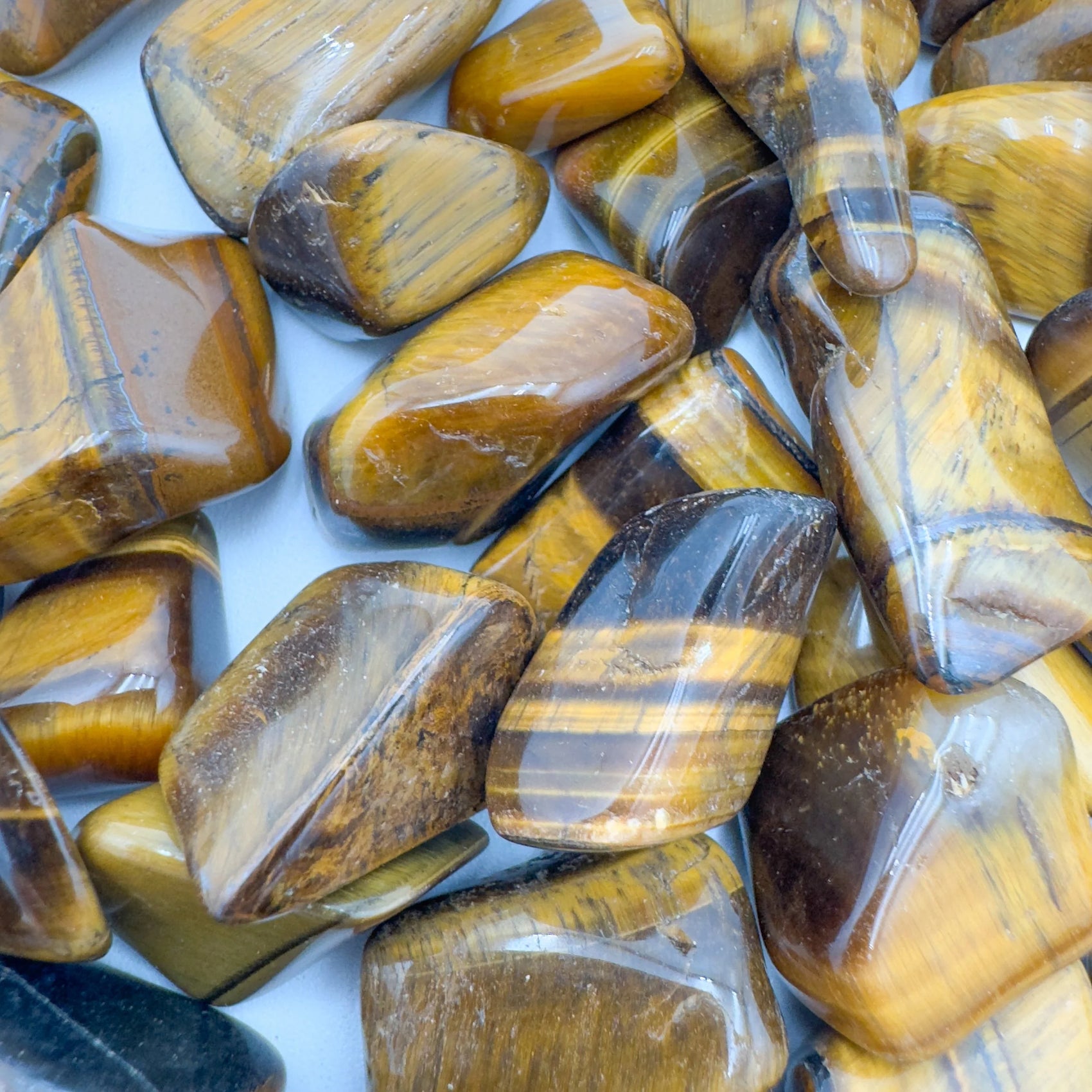 Soft-light view of Tiger Eye tumbled stone, from Northern Cape, South Africa, captured in soft, even lighting.