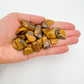 Back view of Grade A Tiger Eye tumbled stone showing natural surface