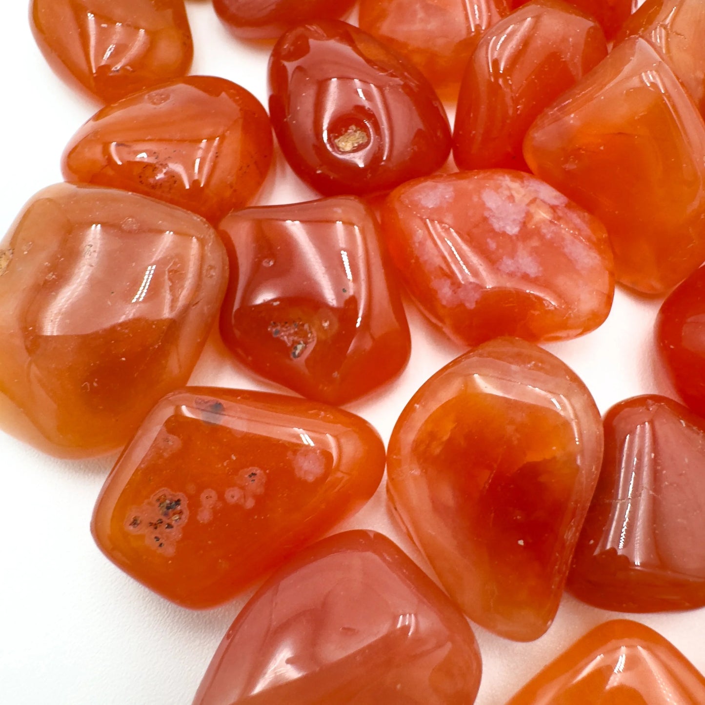 Top view of Grade AA Carnelian tumbled stone, sourced from Francistown, Botswana