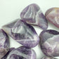 Back view of Grade AA Chevron Amethyst tumbled stone showing natural surface