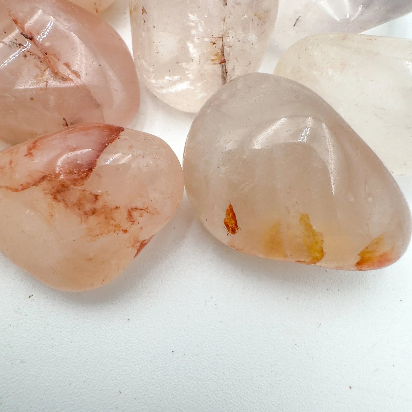 Side angle of Grade AA Fire Quartz tumbled stone, showing earthy tone, often kept for Grounding and Confidence.