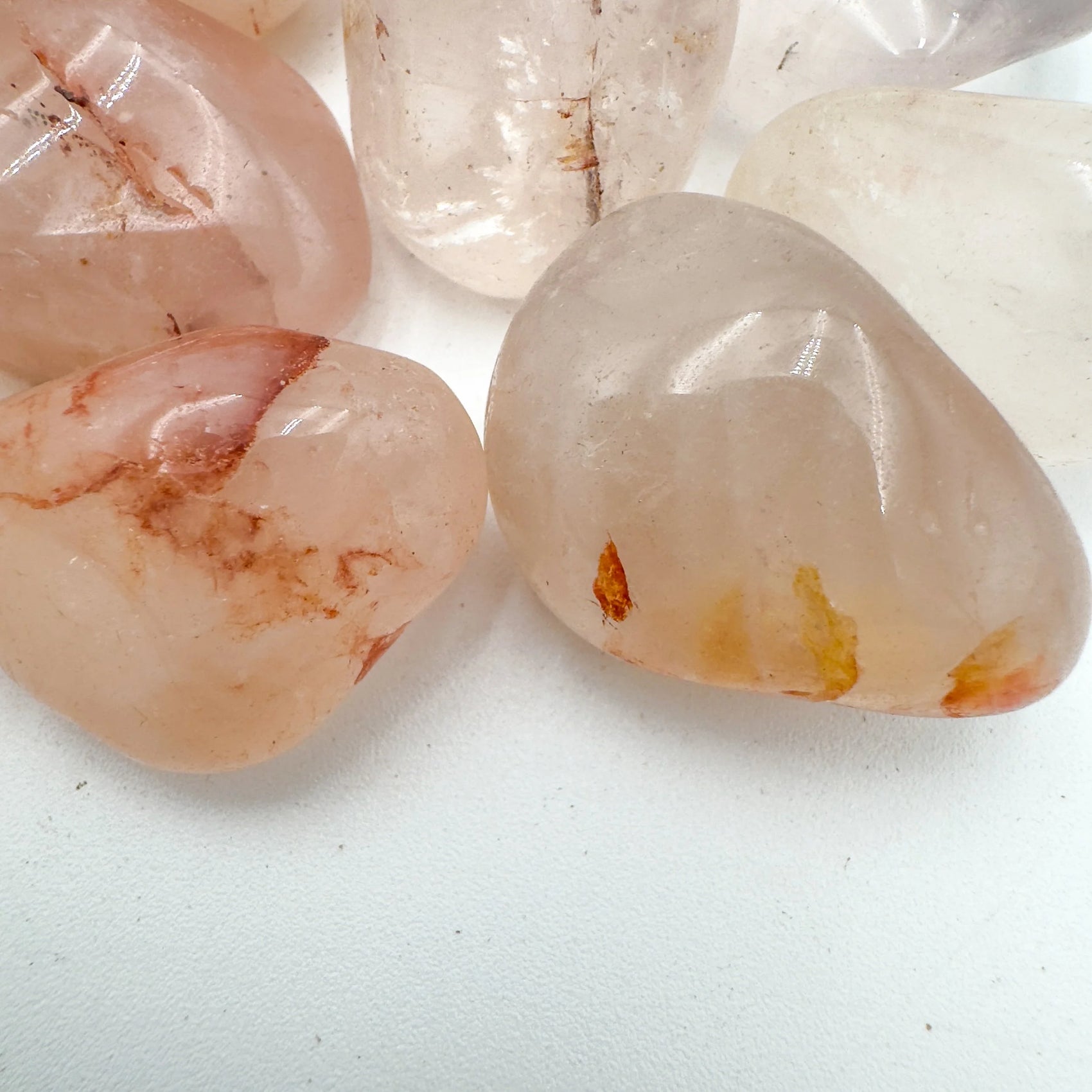 Side angle of Grade AA Fire Quartz tumbled stone, showing earthy tone, often kept for Grounding and Confidence.