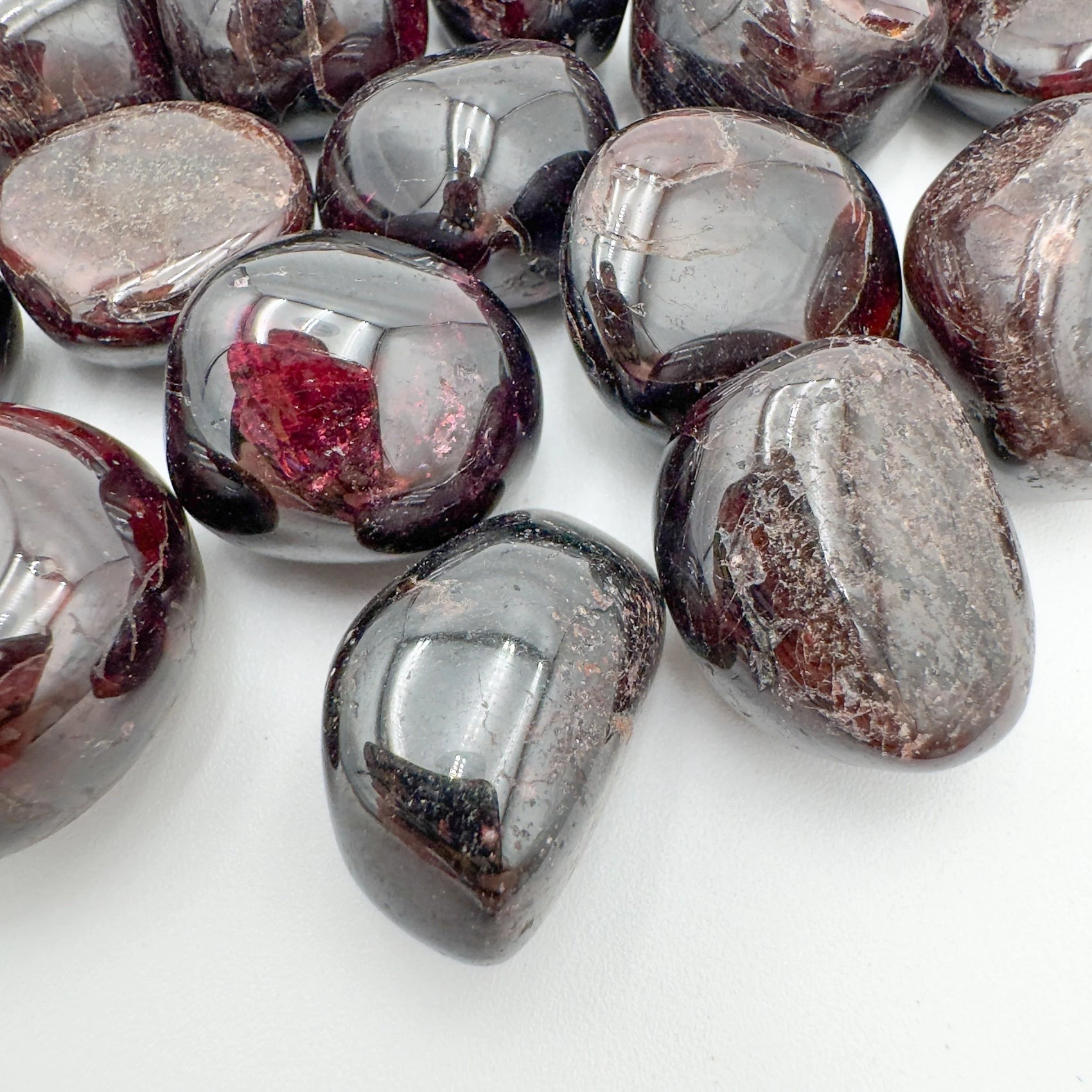 Sideways view of Garnet tumbled stone, showing soft luster, Malawi-sourced.