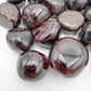 Top-side view of Garnet tumbled stone, kept near for Energy and Confidence, showing natural inclusions.