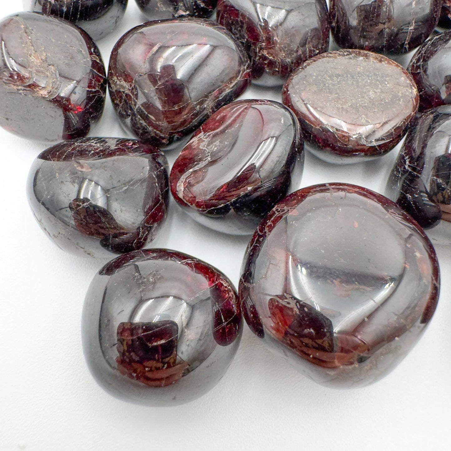 Top-side view of Garnet tumbled stone, kept near for Energy and Confidence, showing natural inclusions.
