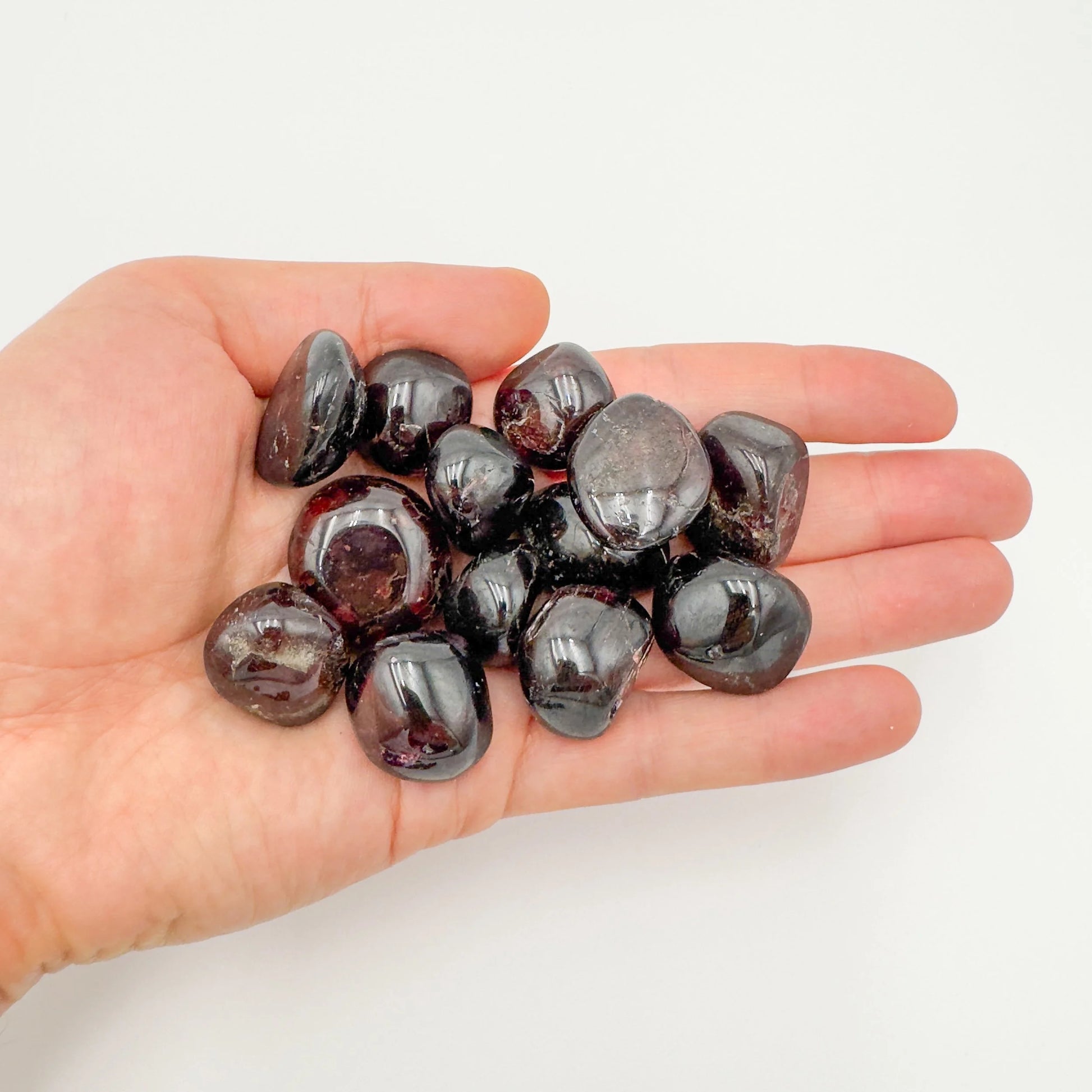Back view of Grade AAA Garnet tumbled stone showing natural surface