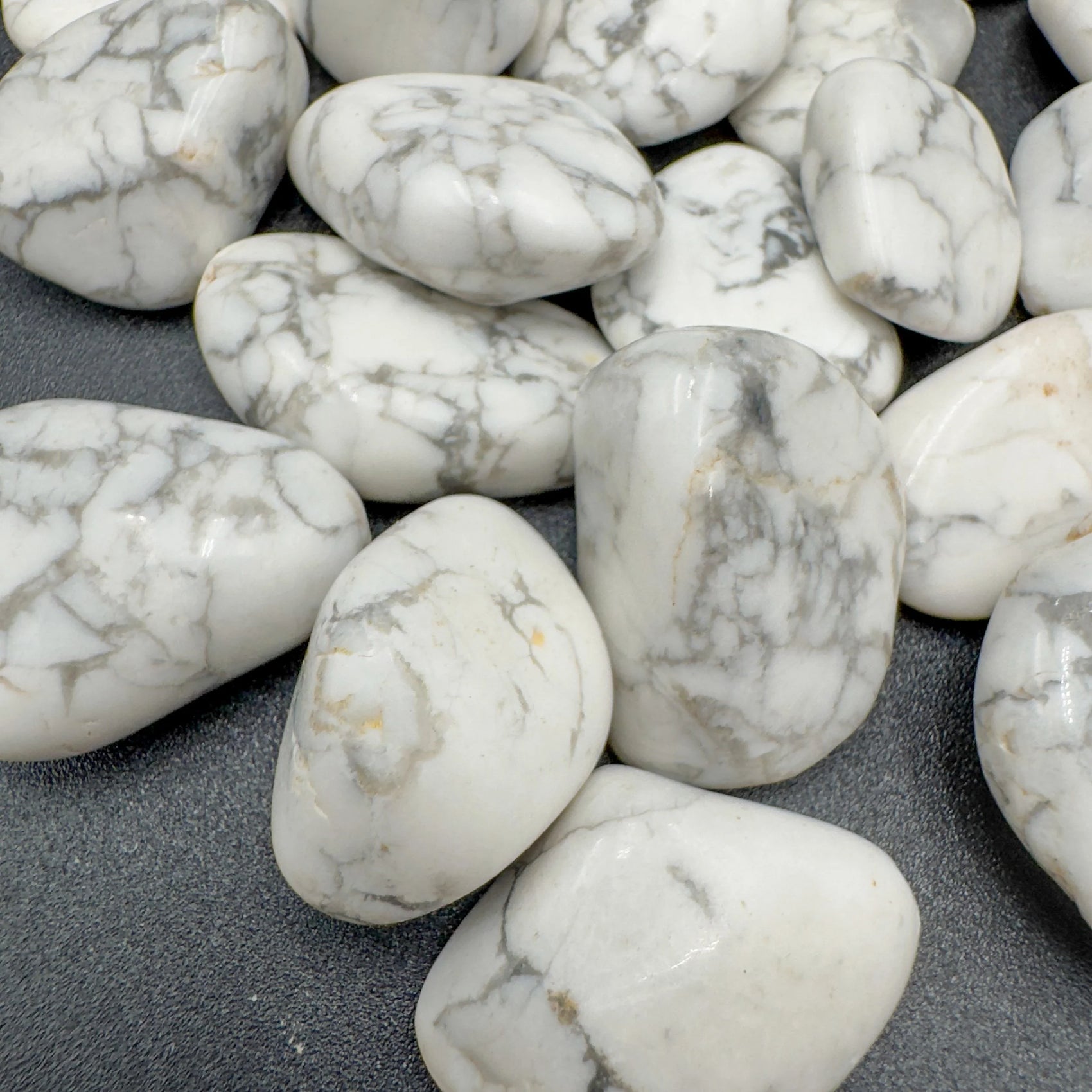 Side angle of Howlite tumbled stone, hand-selected from Masvingo, Zimbabwe, showing characteristic finish.
