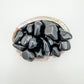 Up-close view of Rainbow Obsidian tumbled stone, often kept for Emotional Healing.