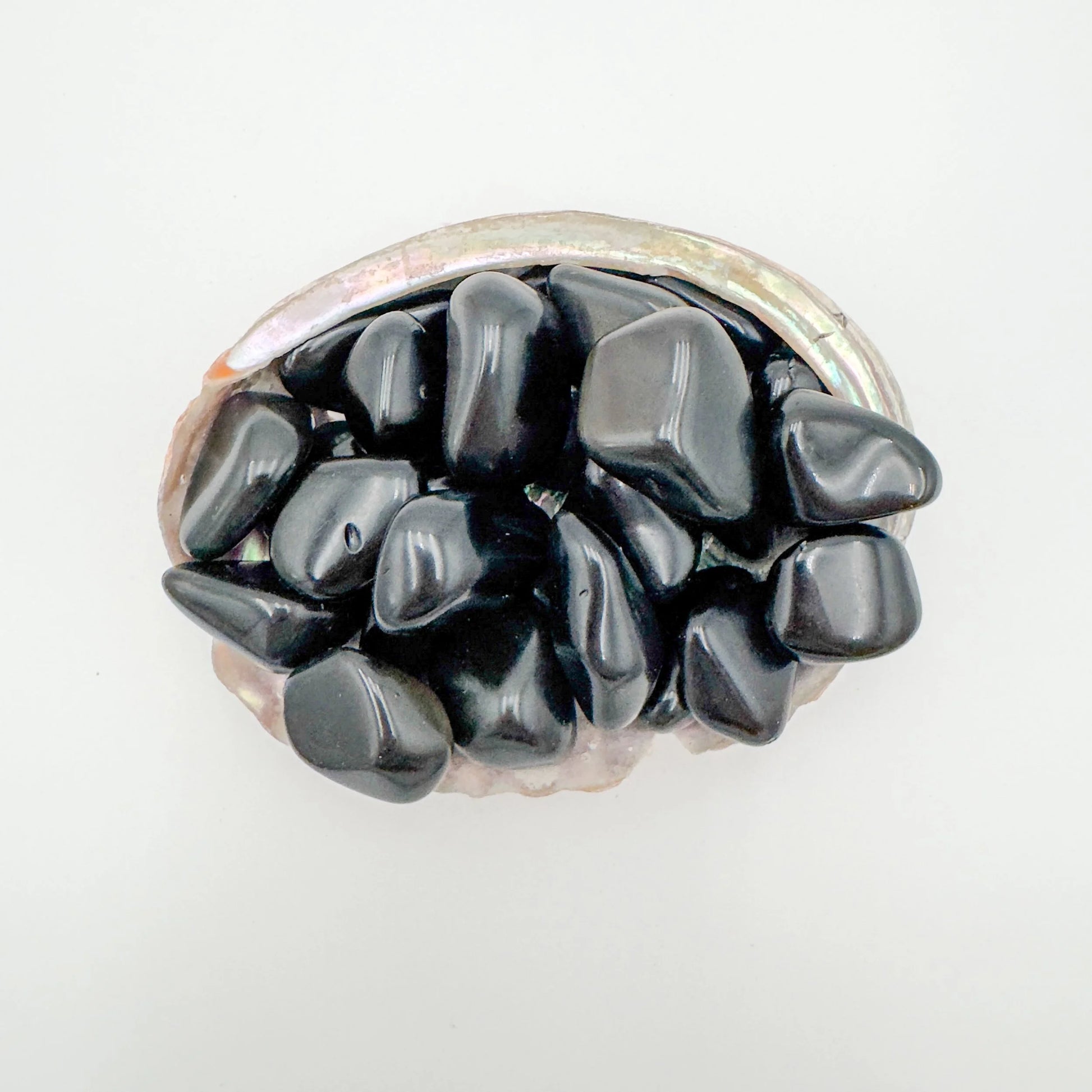 Up-close view of Rainbow Obsidian tumbled stone, often kept for Emotional Healing.