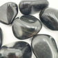 Rear view of Rainbow Obsidian tumbled stone, showing natural inclusions.