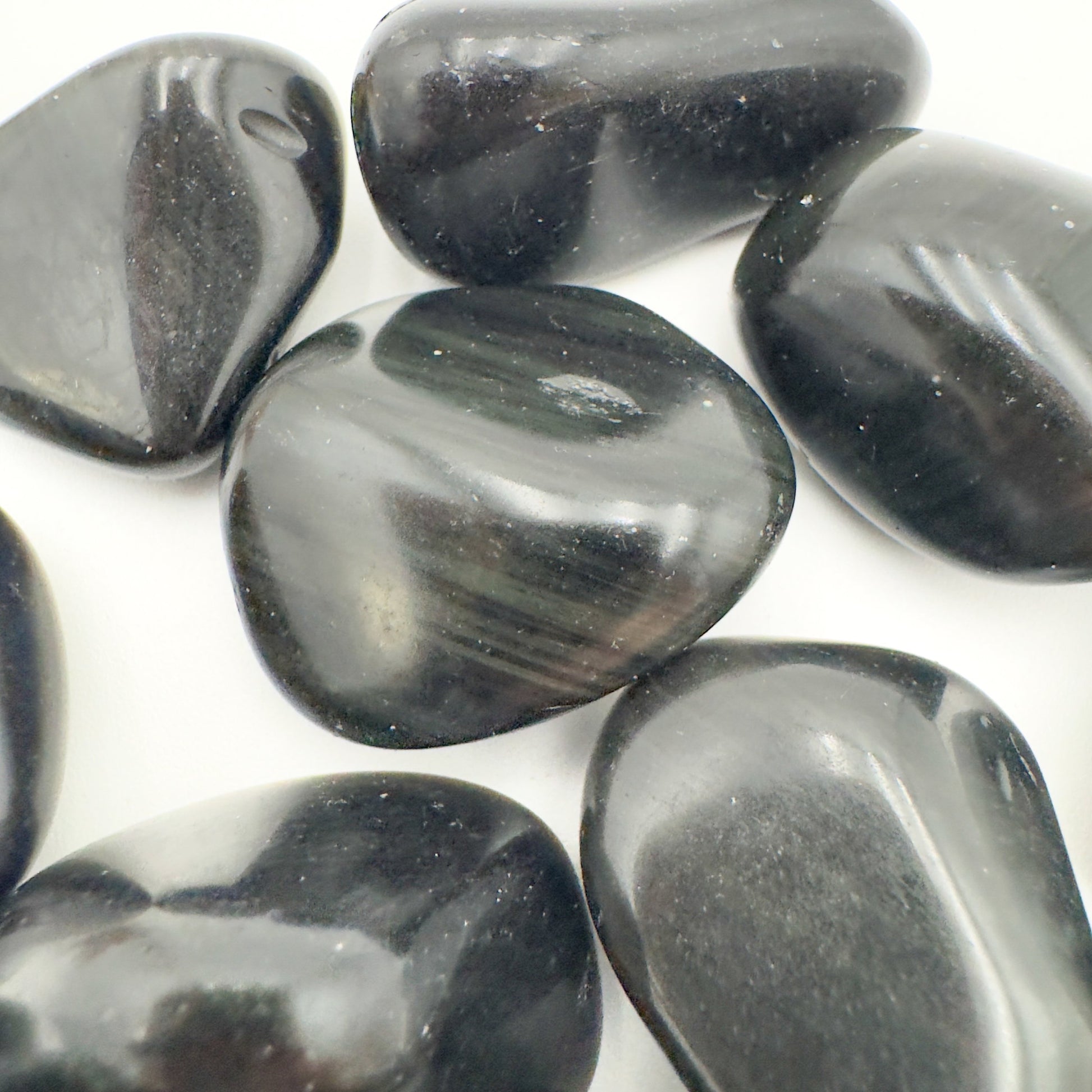 Rear view of Rainbow Obsidian tumbled stone, showing natural inclusions.