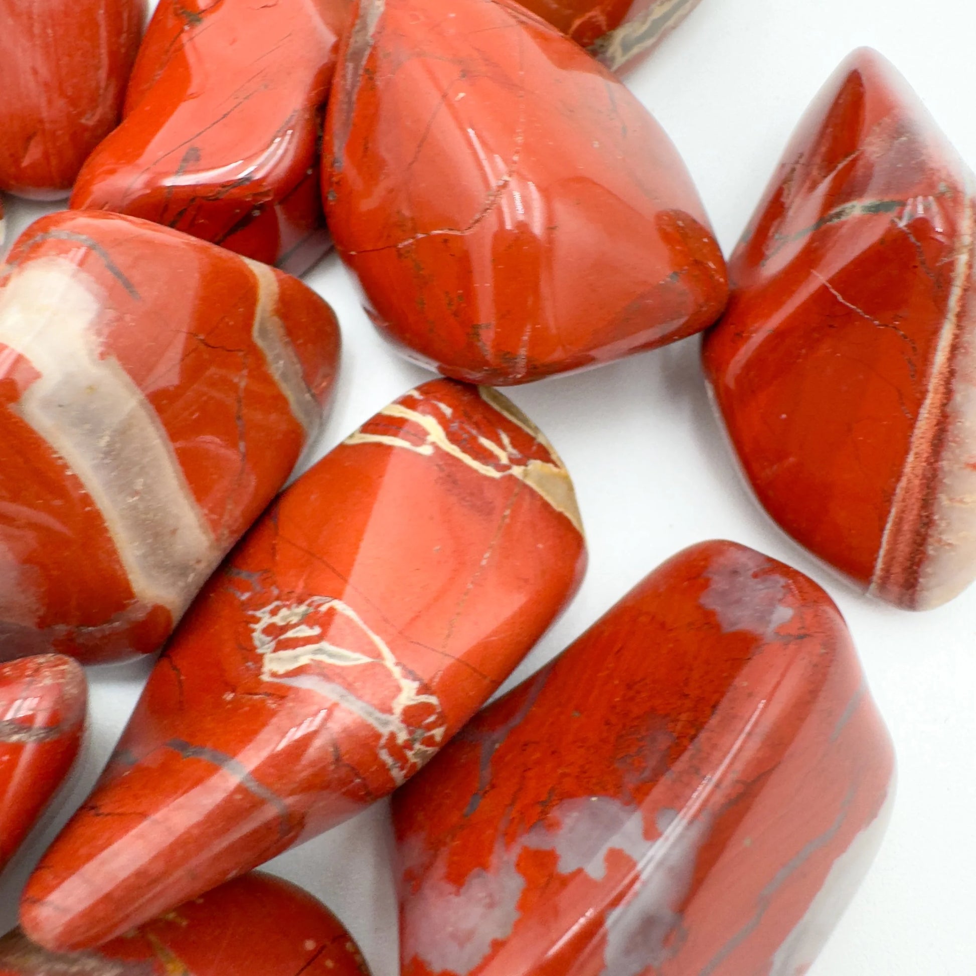 Close-up of Red Jasper tumbled stone from South Africa, soothing wellness stone for Confidence