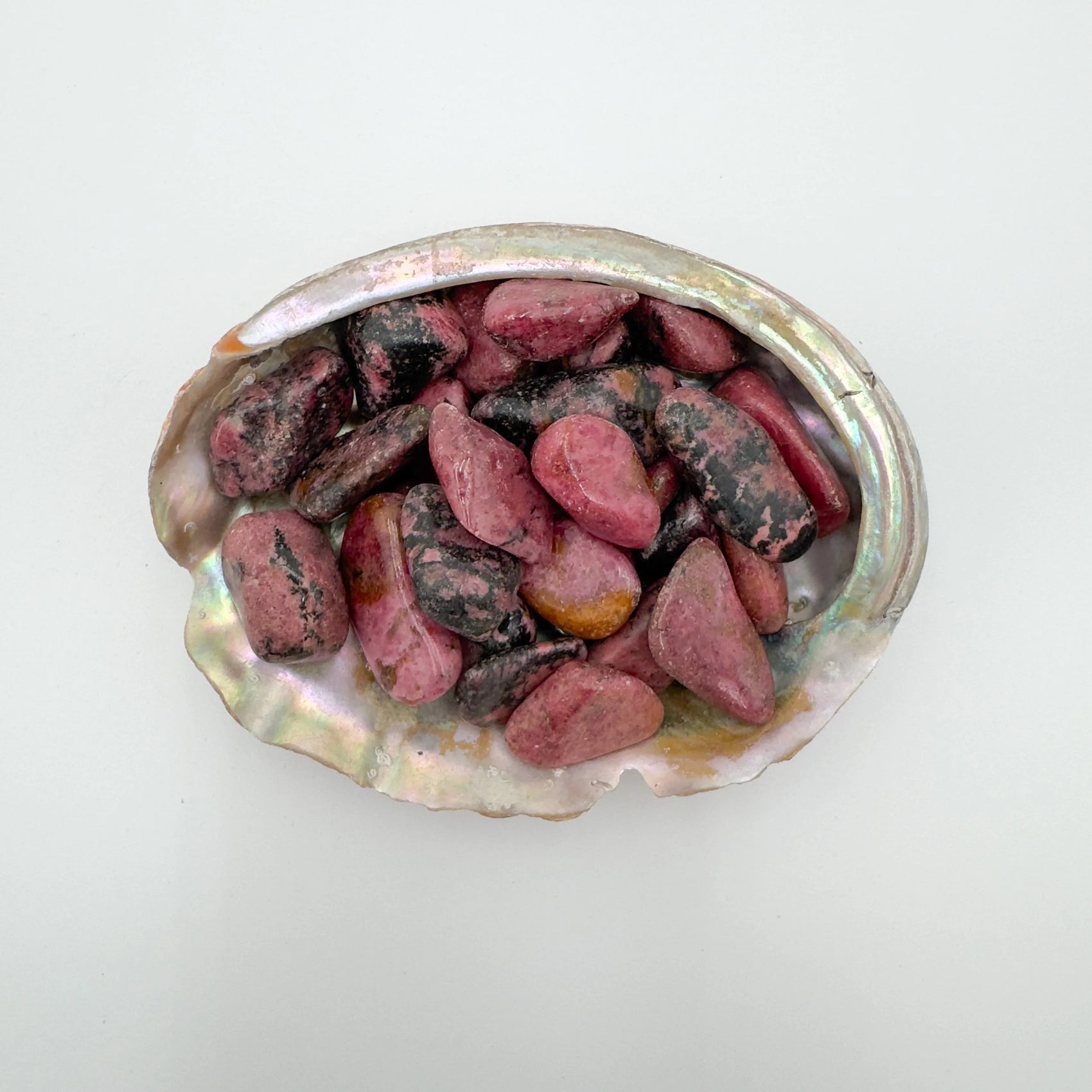 Rhodonite tumbled stone in Pink, Black tones, ethically sourced from Zimbabwe for Emotional Healing and Love