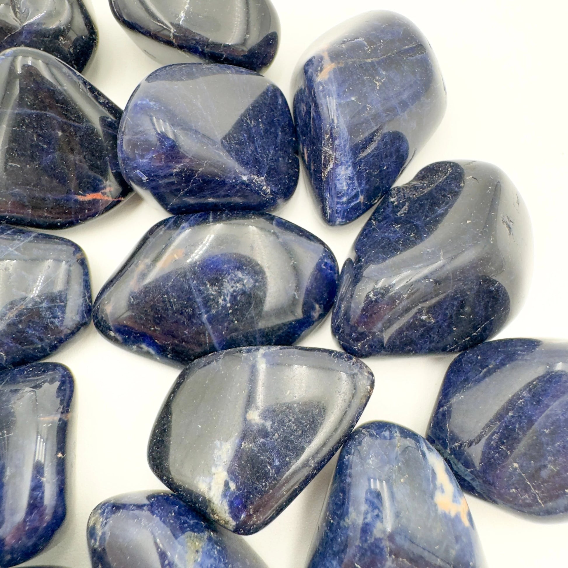 Hand-held view of a single Sodalite tumbled stone Namibia-sourced, from Namibia.