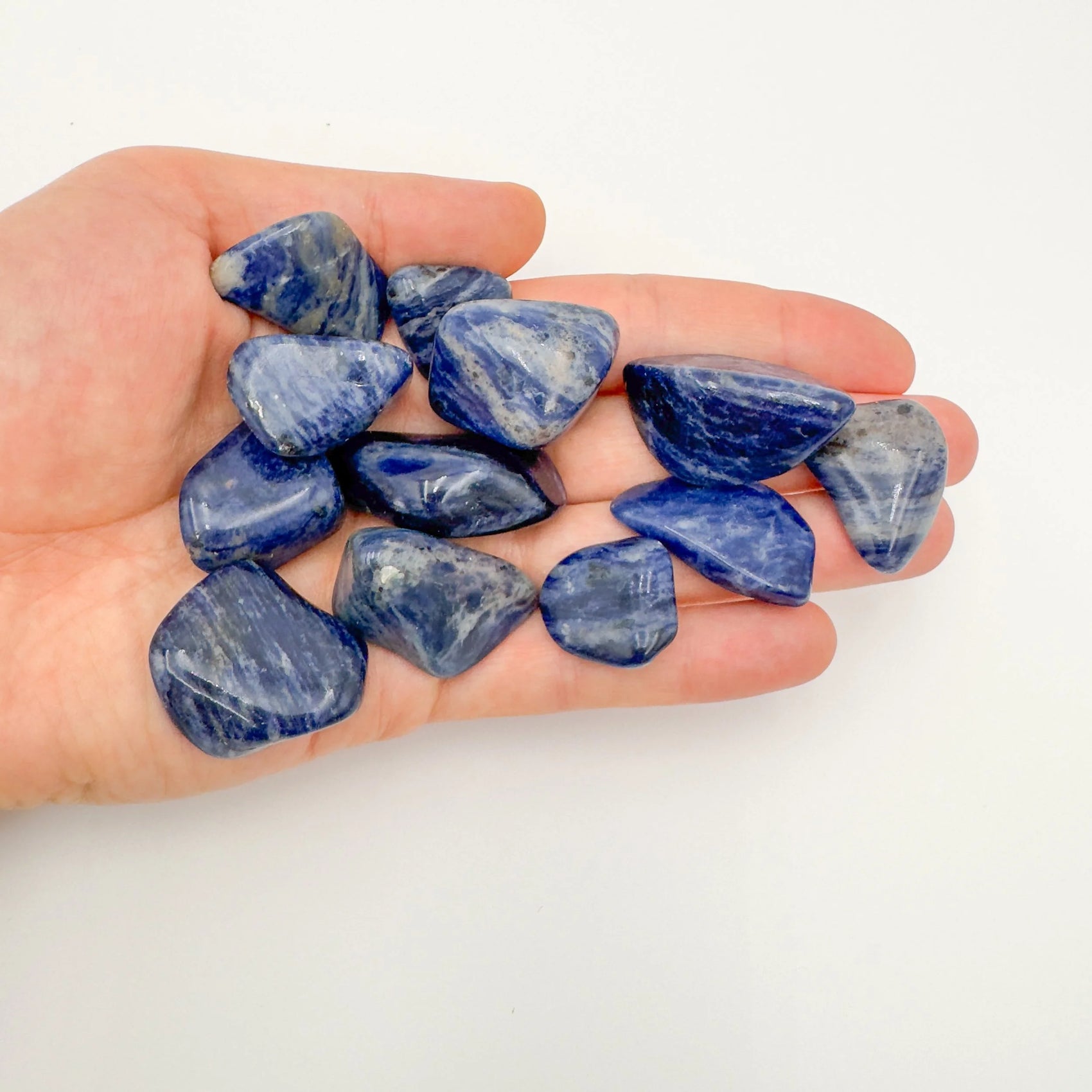 Back view of Grade A Sodalite tumbled stone showing natural surface