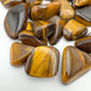 Side angle of Tiger Eye tumbled stone, kept near for Confidence, hand-selected from Northern Cape, South Africa.