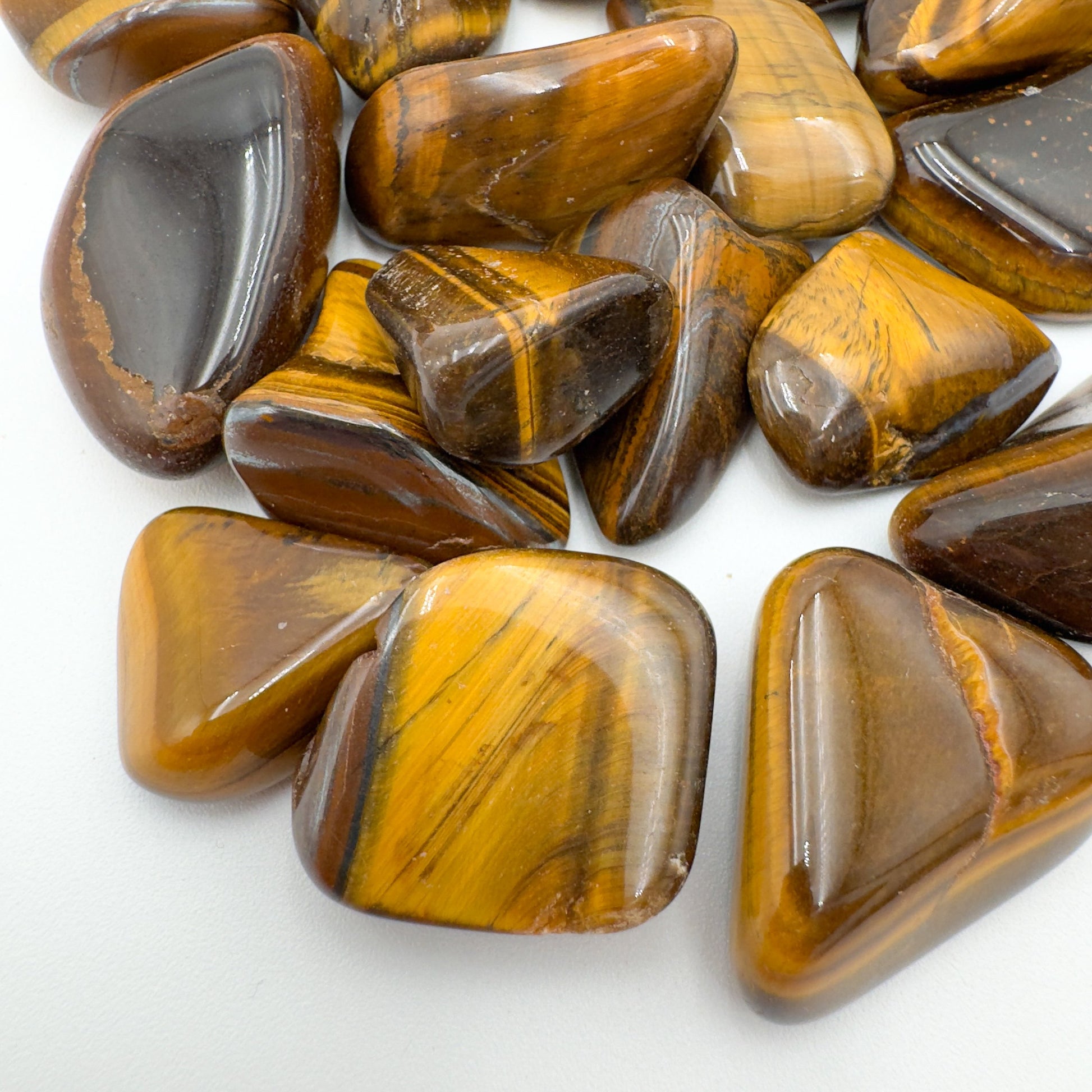 Side angle of Tiger Eye tumbled stone, kept near for Confidence, hand-selected from Northern Cape, South Africa.