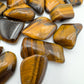 Aerial view of brown Tiger Eye tumbled stone, for Confidence.