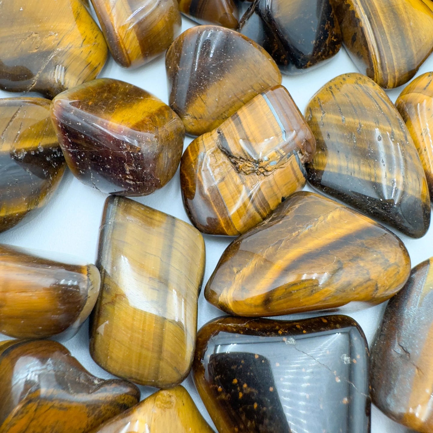 Reverse angle of Grade A Tiger Eye tumbled stone, sourced from South Africa.