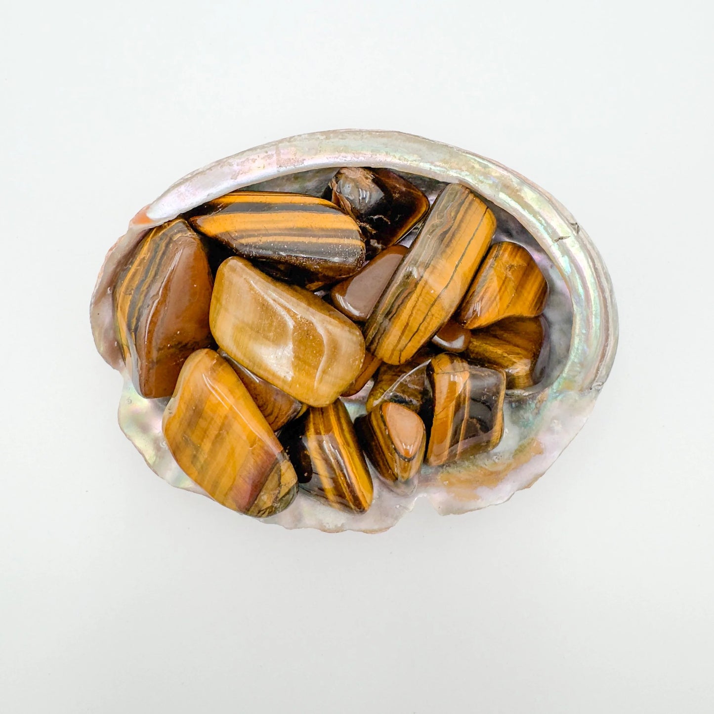 Detail capture of brown Tiger Eye tumbled stone, showing characteristic color.