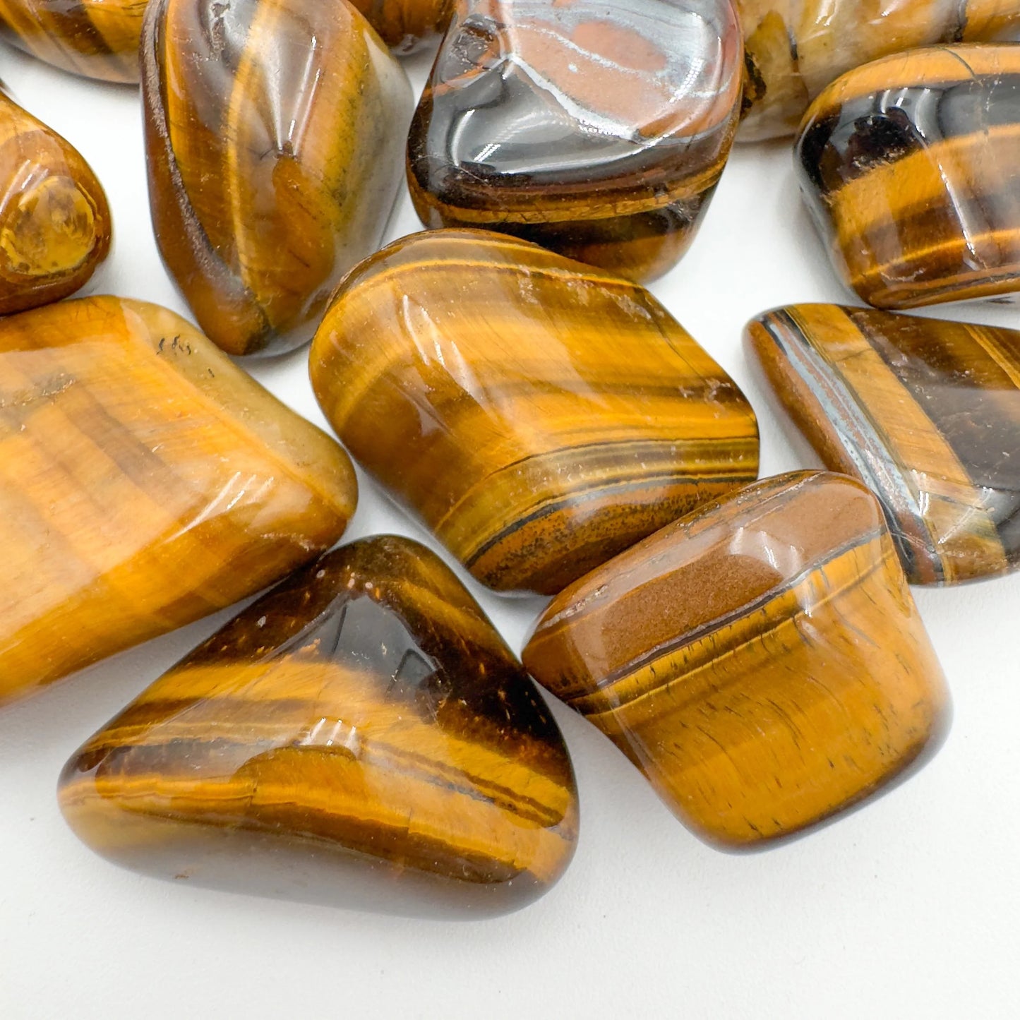 Side profile of Tiger Eye tumbled stone, sourced from Northern Cape, South Africa, worked with for Confidence.