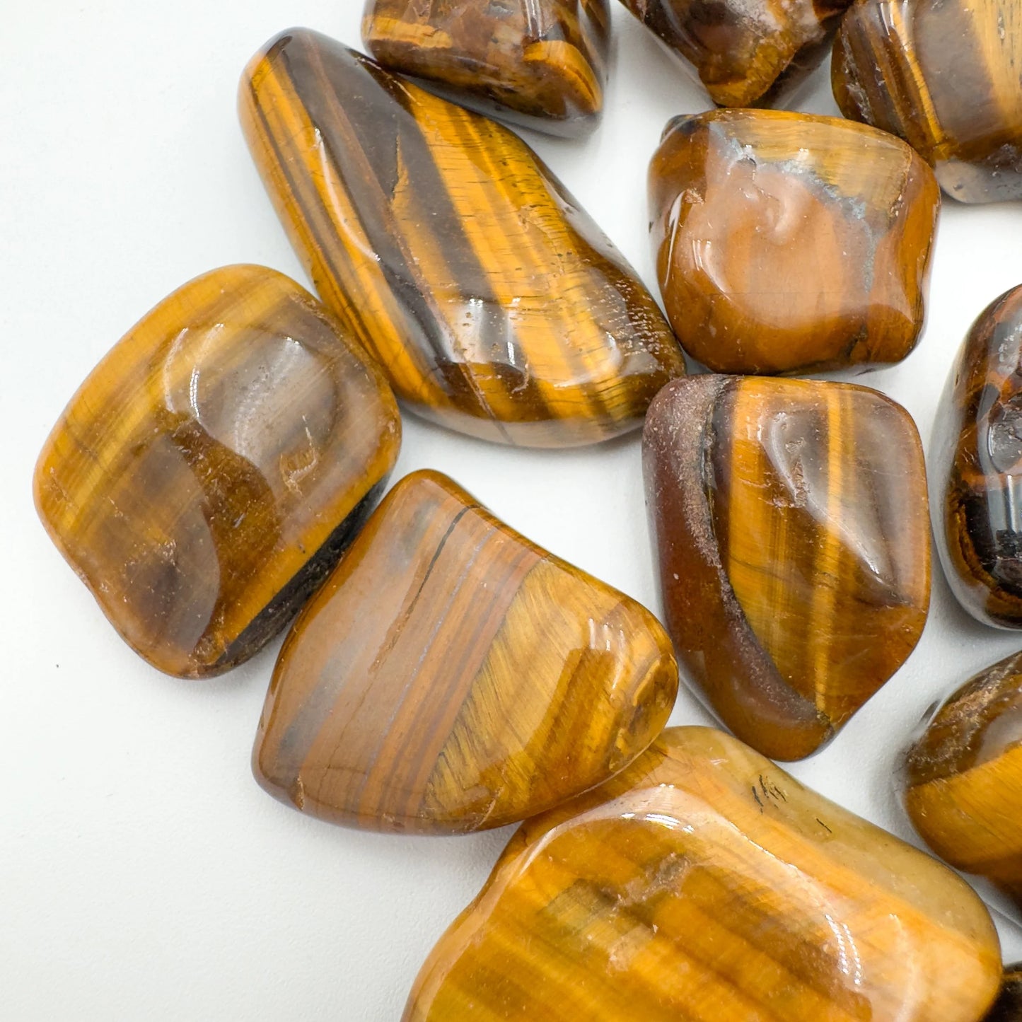 Bird's-eye view of Tiger Eye tumbled stone, from South Africa, showing natural sheen.