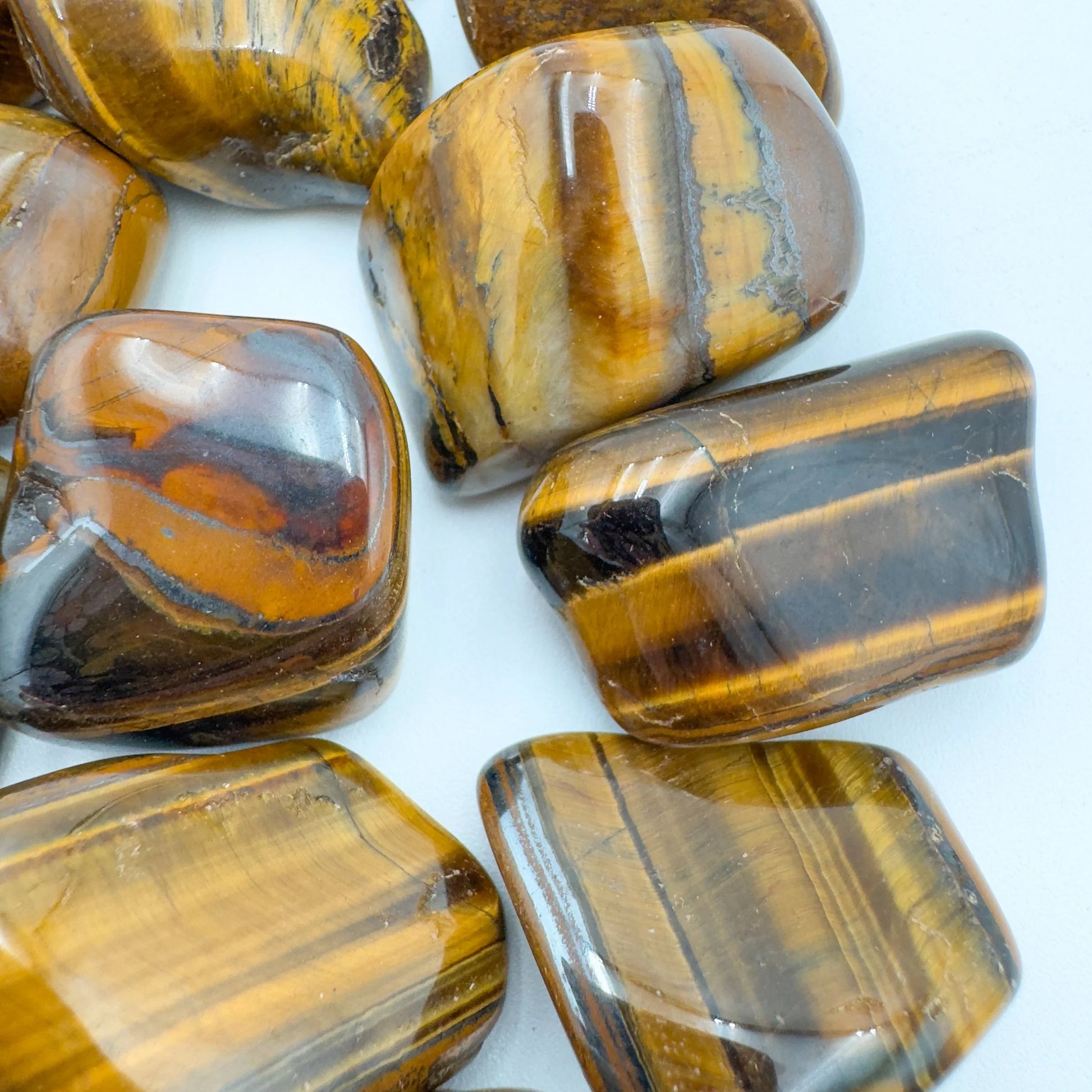 Opposite side of Tiger Eye tumbled stone, hand-selected from Northern Cape, South Africa, showing characteristic finish.