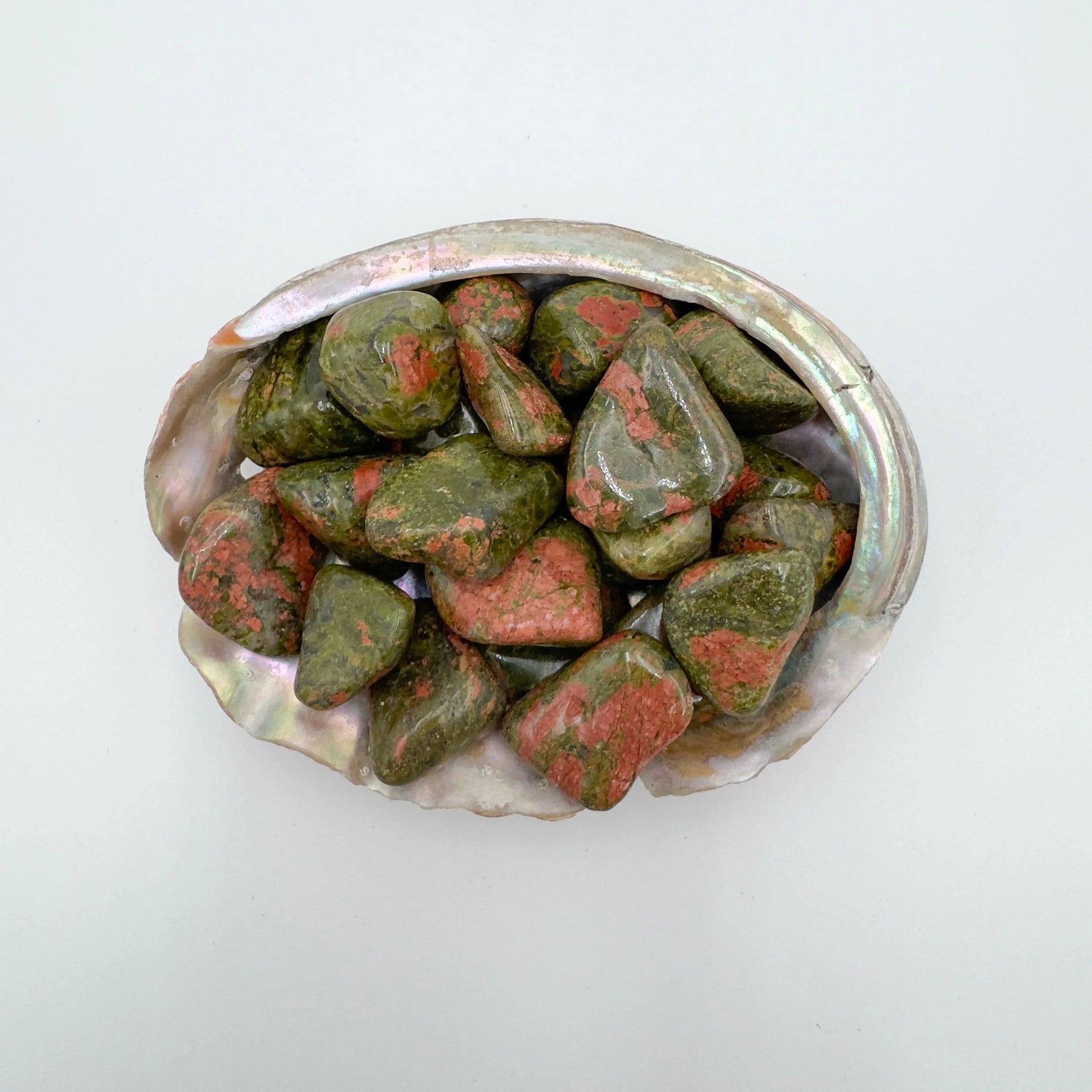 Near view of Grade AA Unakite tumbled stone, linked to Emotional Healing and Healing, showing natural texture.