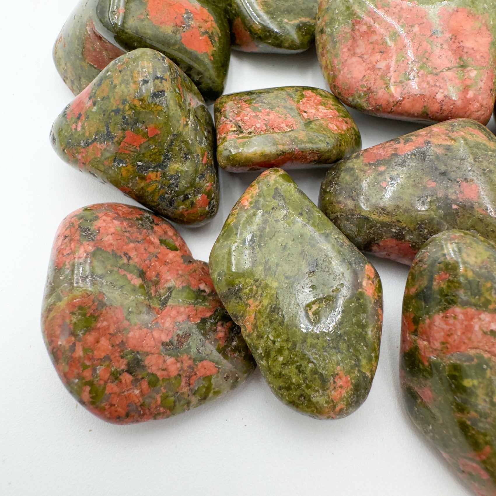 Side-on view of Unakite tumbled stone, drawn on for Emotional Healing and Healing.