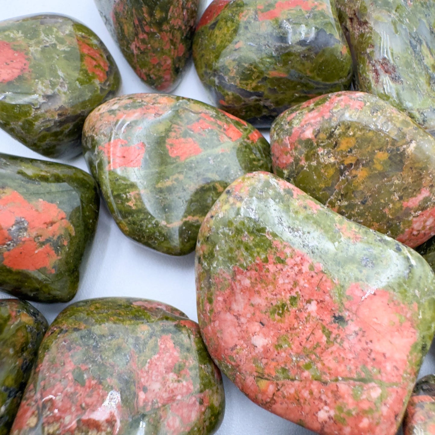Underside detail of Unakite tumbled stone, showing natural sheen, turned to for Emotional Healing.