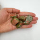 Natural light view of one Unakite tumbled stone for scale, sourced from Northern Cape, South Africa.