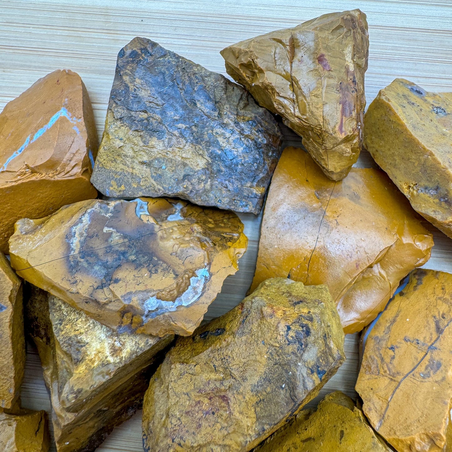 Scale reference of a Yellow Jasper raw stone held against natural backdrop.