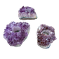 Amethyst candle holders grouped, showing variation in purple depth and crystal point size