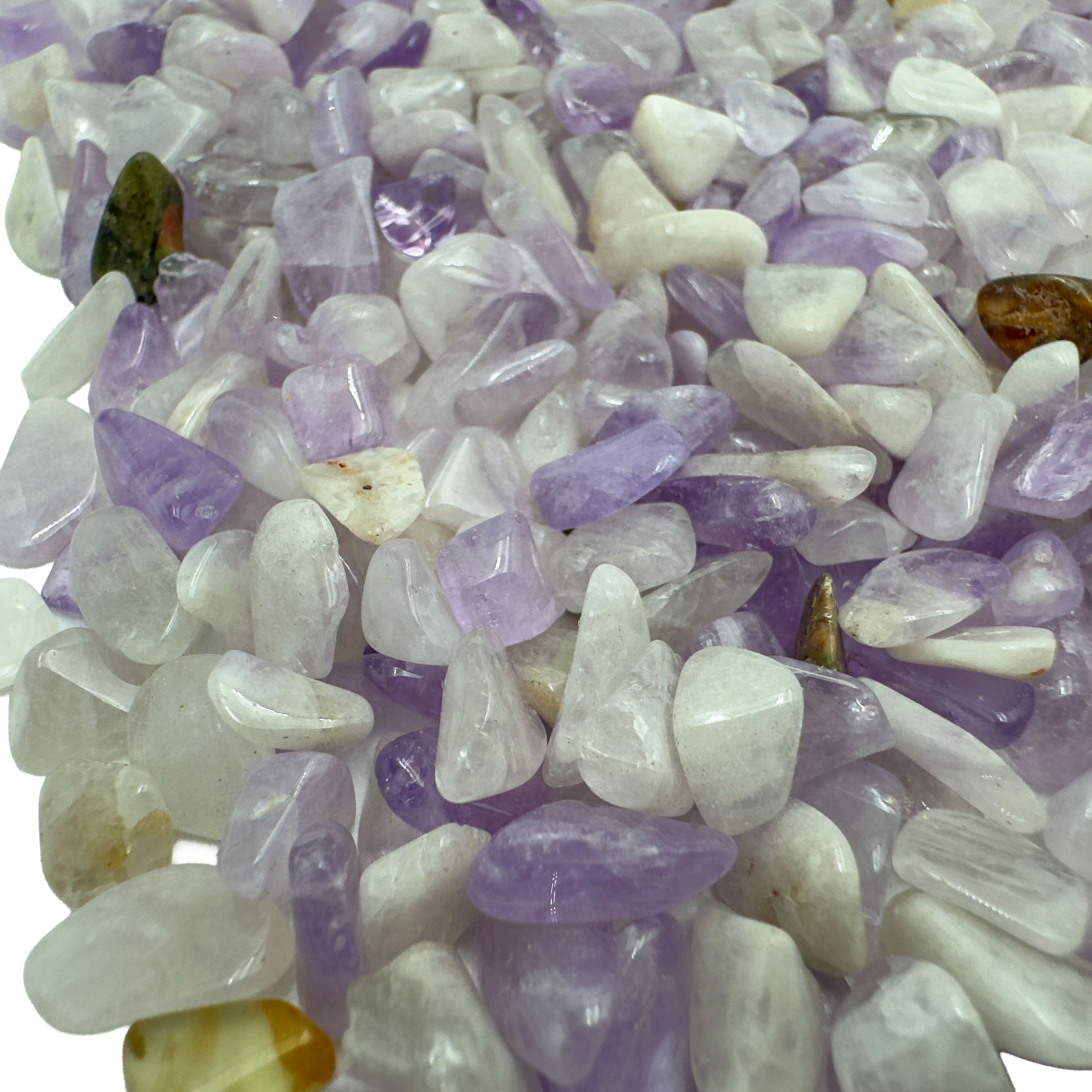 Amethyst polished chips in hand showing size reference, violet Madagascar quartz