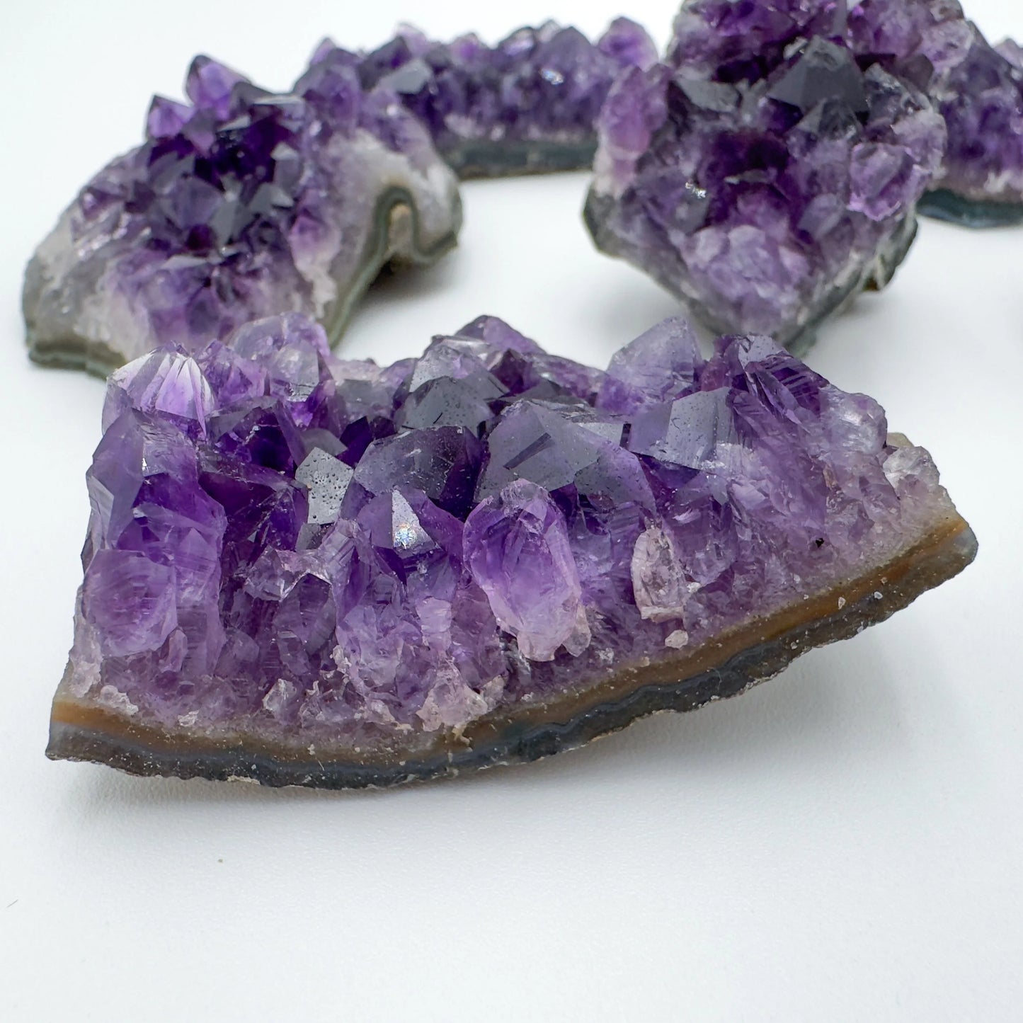 Grade aa amethyst cluster held in hand for size reference