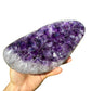 Grade aaa amethyst geode held in hand for size reference