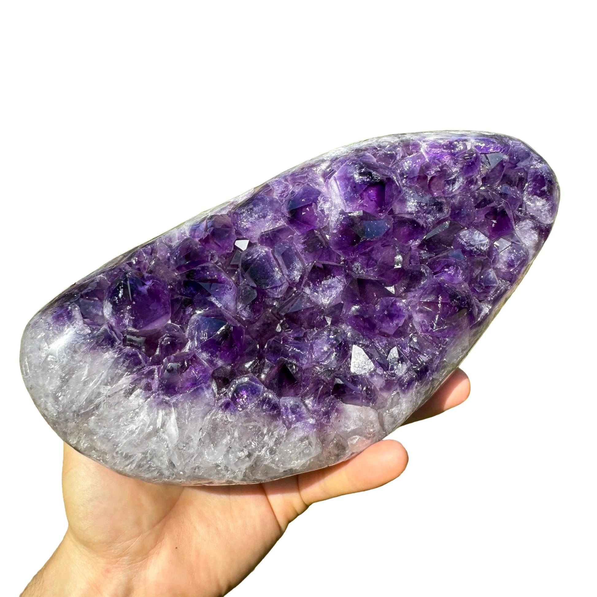 Grade aaa amethyst geode held in hand for size reference