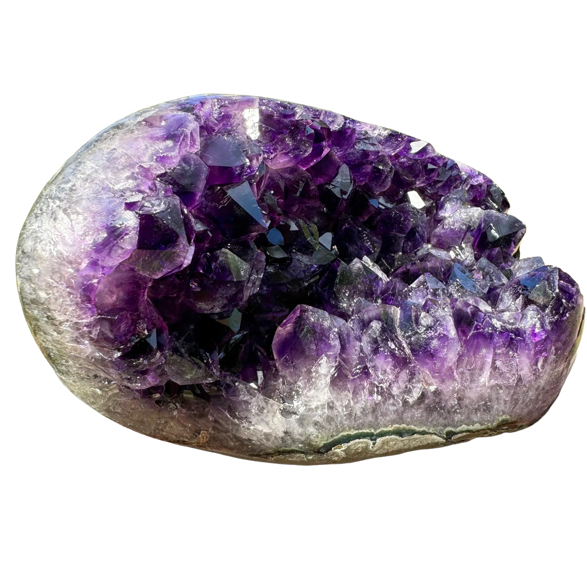 Scale reference of a Amethyst raw geode held against natural backdrop.