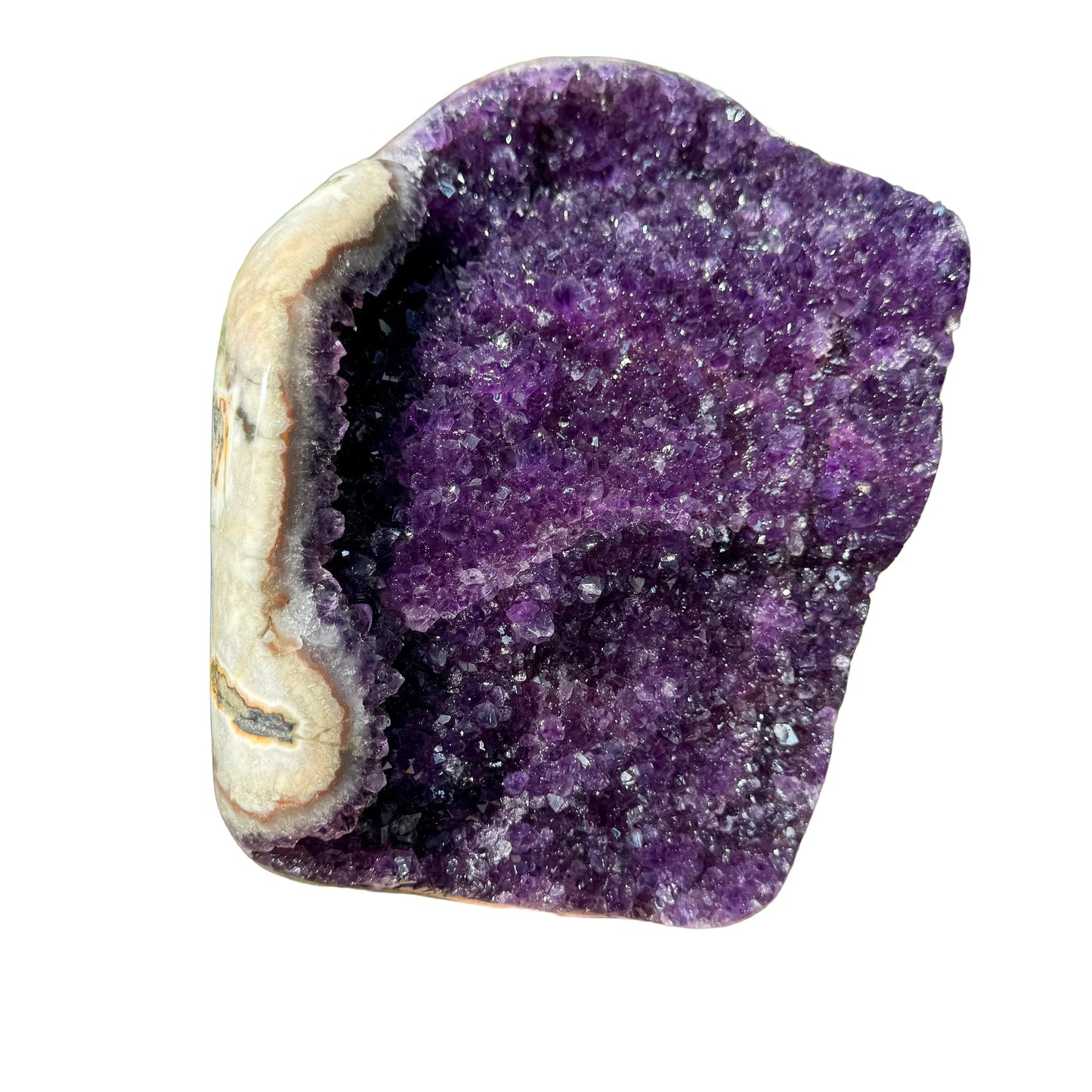 Grade aa amethyst geode held in hand for size reference