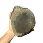 Grade aaa amethyst geode held in hand for size reference