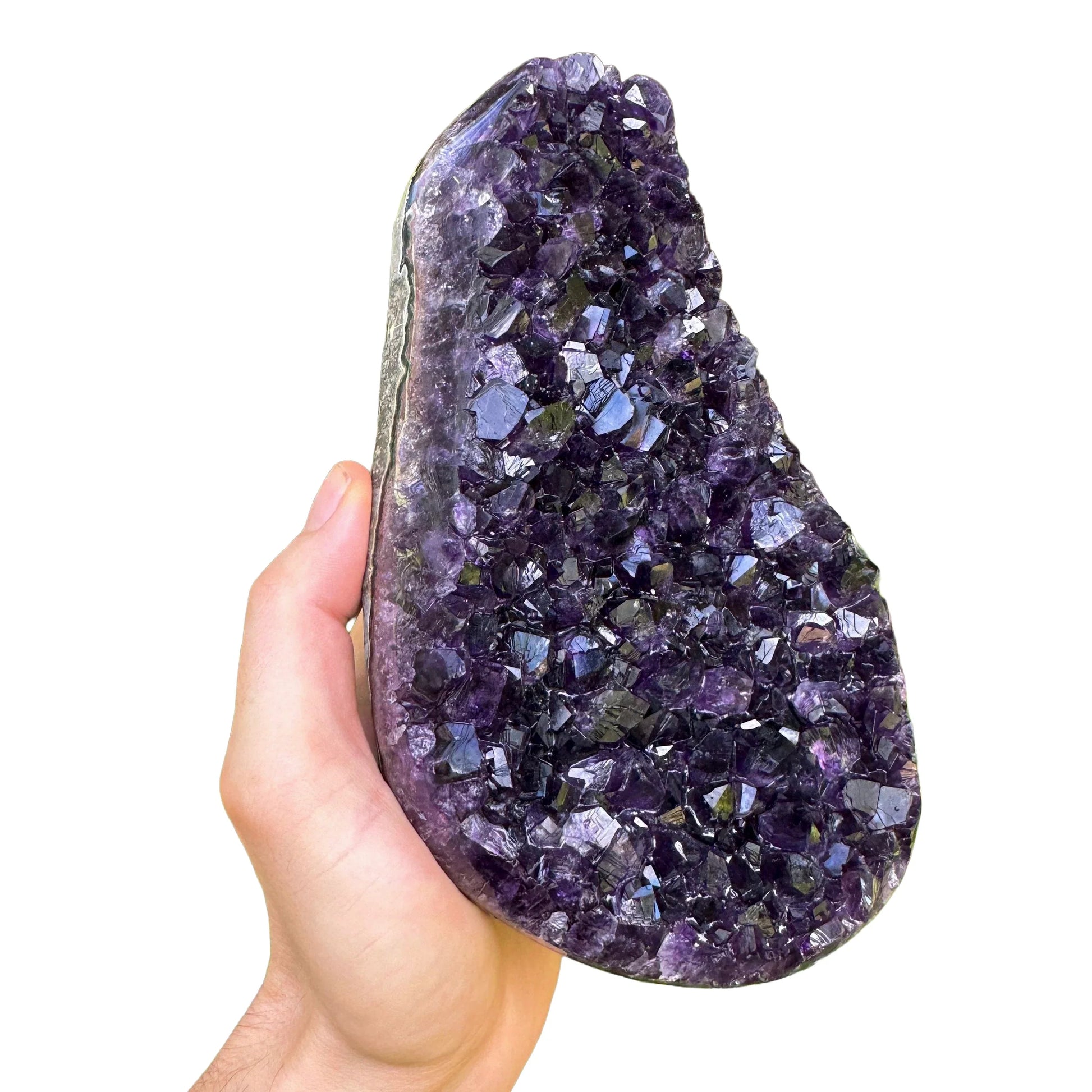 Grade aaa amethyst geode held in hand for size reference
