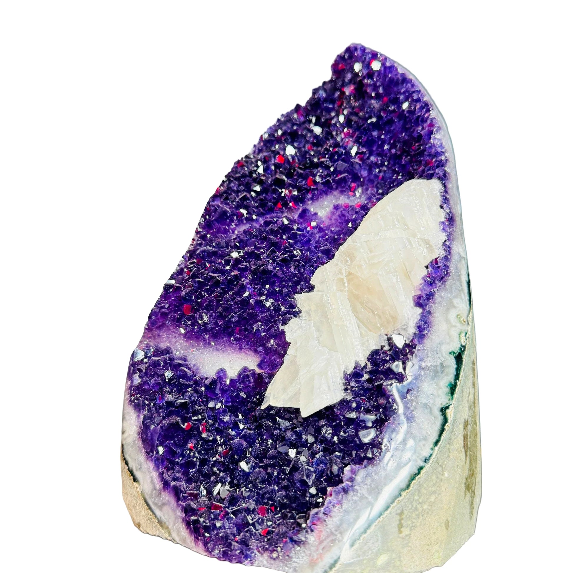 Palm-scale view of a Amethyst raw geode held against natural backdrop.