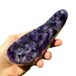 Grade aaa amethyst geode held in hand for size reference