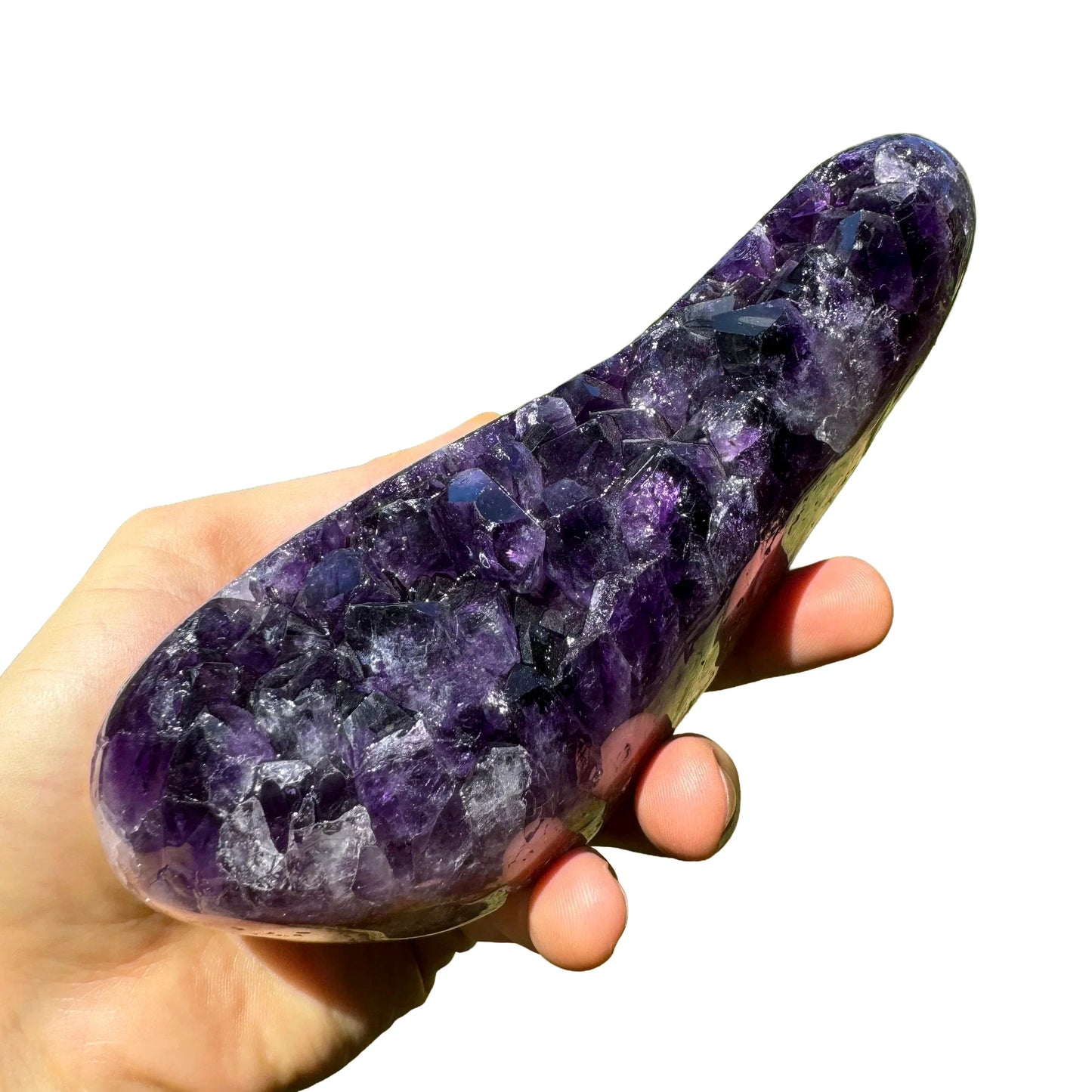Grade aaa amethyst geode held in hand for size reference