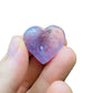 Side-on view of Amethyst polished heart, showing characteristic color, from Brazil.