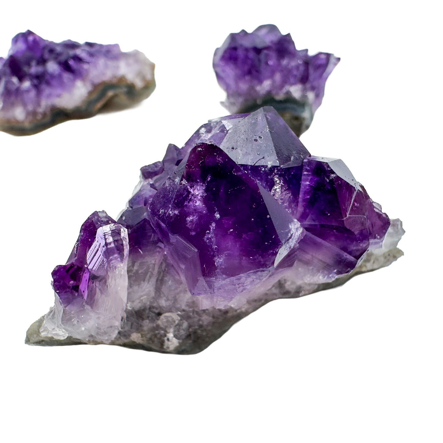 Variety of Uruguayan Amethyst clusters in deep saturated purple, formed in volcanic basalt geode cavities
