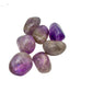 Side view of Amethyst tumbled stones showing polish across the curved faces