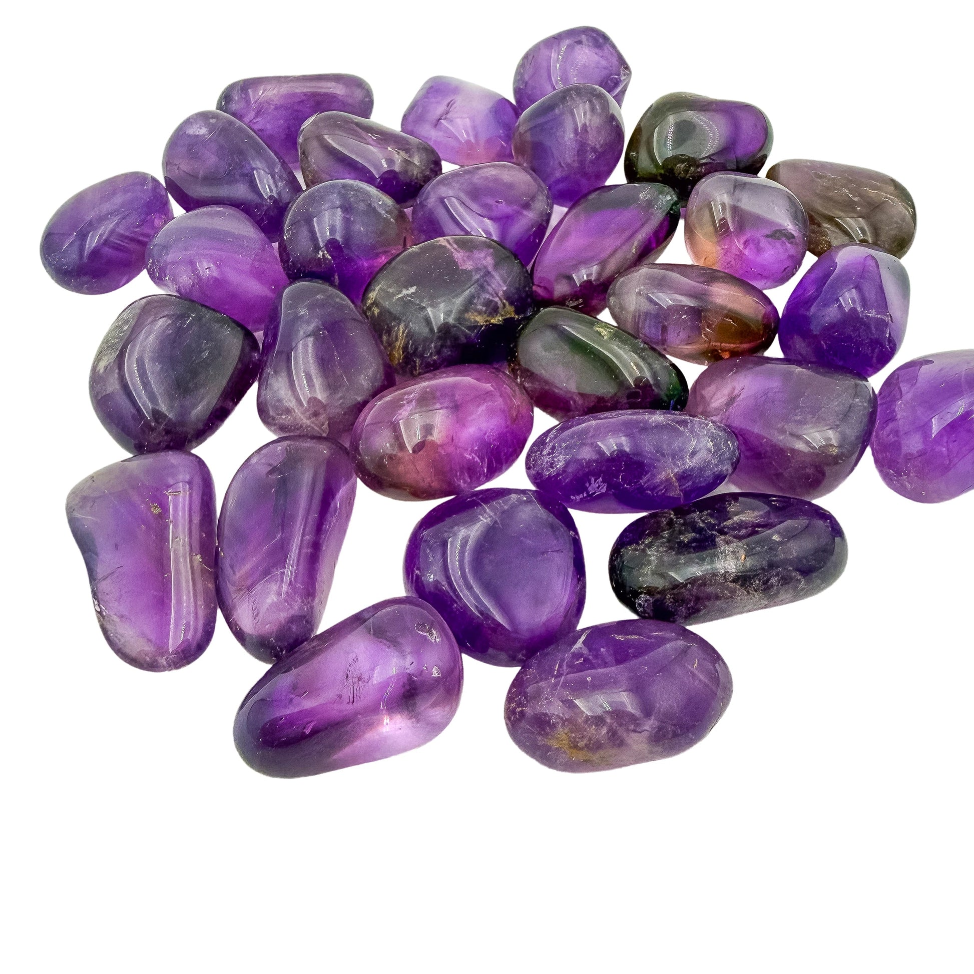 Angled view across Ametrine tumbles showing purple and gold zoning in each stone